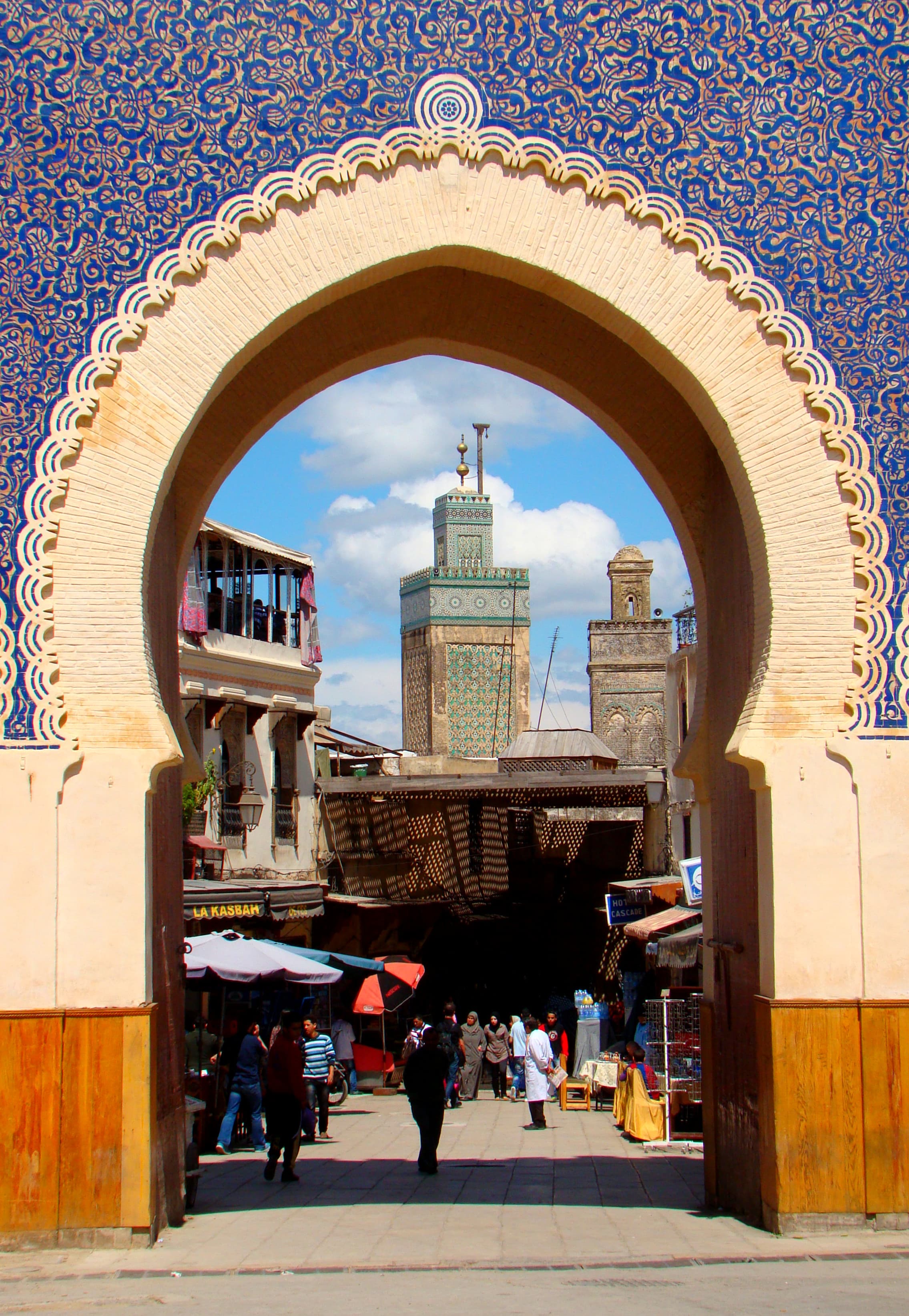 The minaret of Bou Inania Madrasa can be seen through Bab Bou Jeloud, approximately 150 meters away.