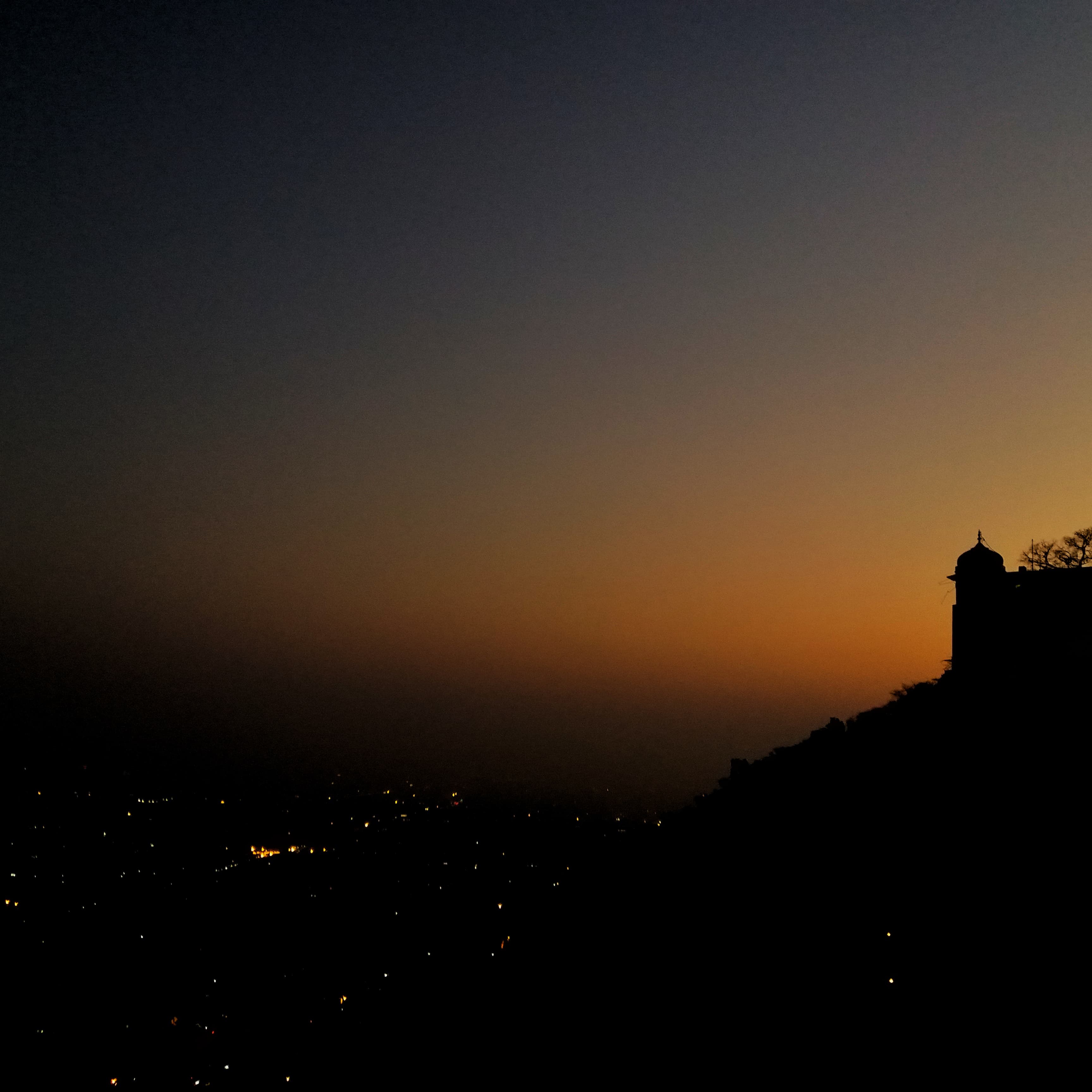 Night view of Nahargarh Fort from the back, with Jaipur city below.
