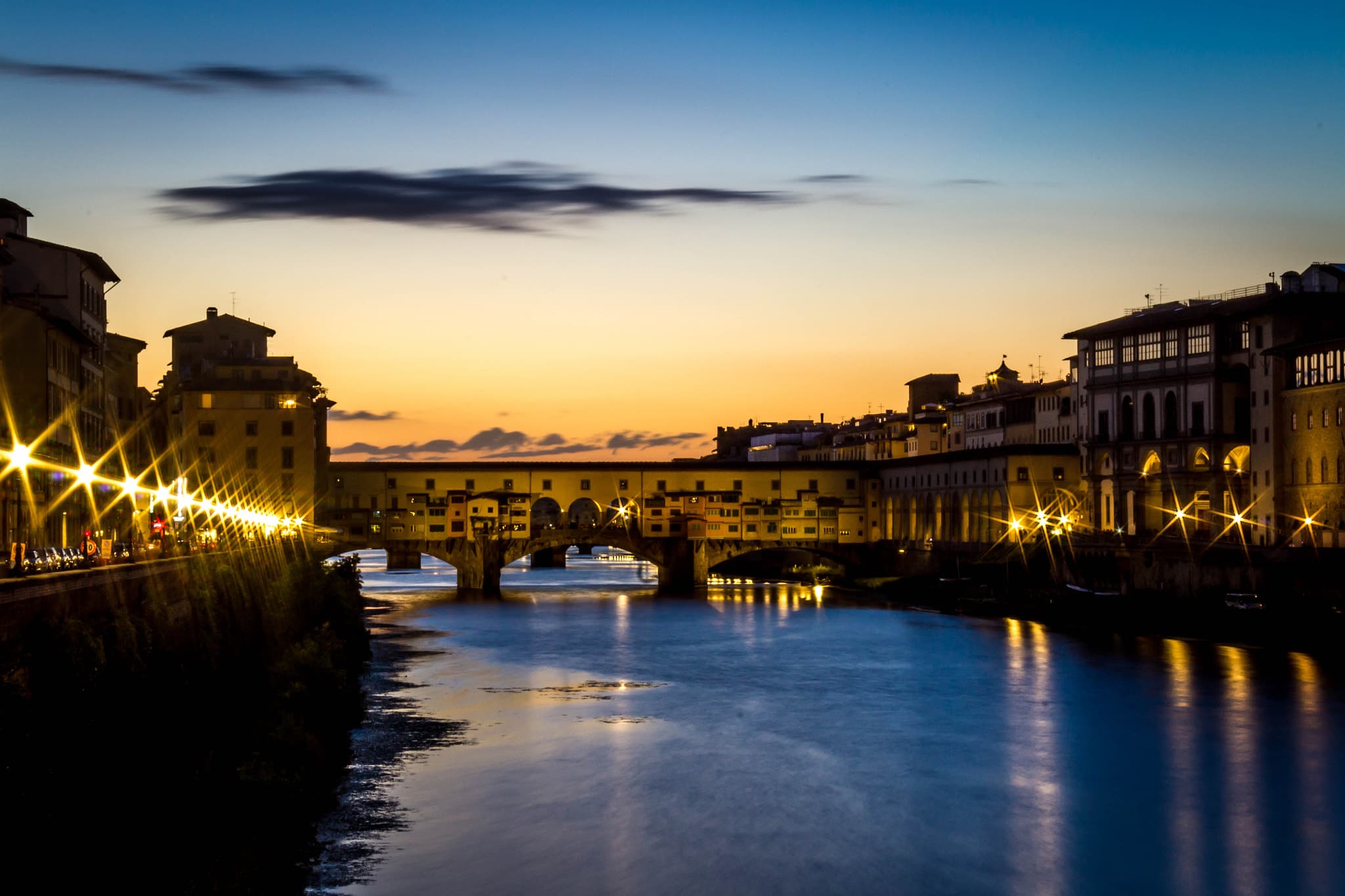 Drinking a Spritz near Ponte Vecchio just after a majestic summer sunset.